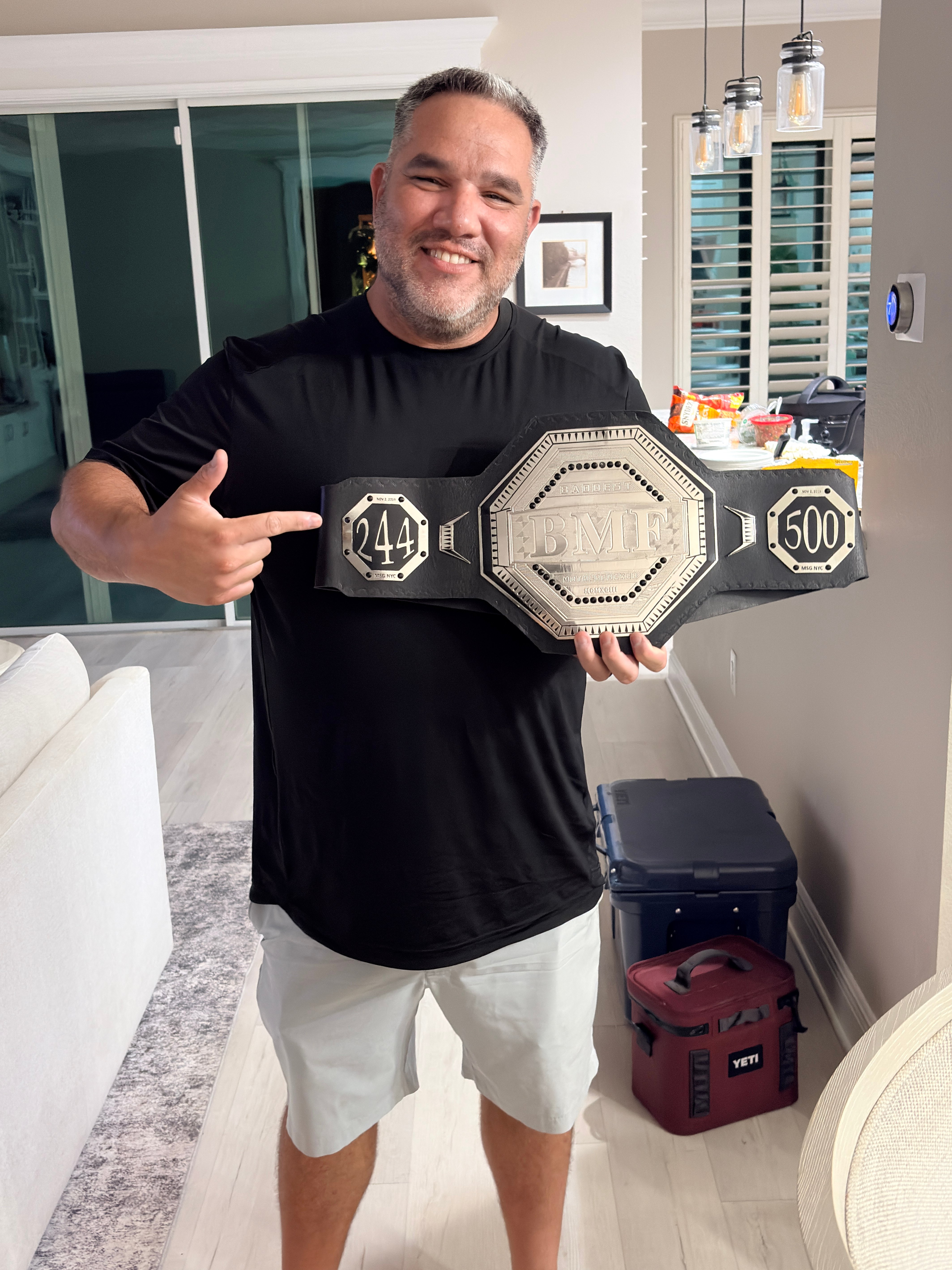 Dre proudly holding up a BMF championship belt